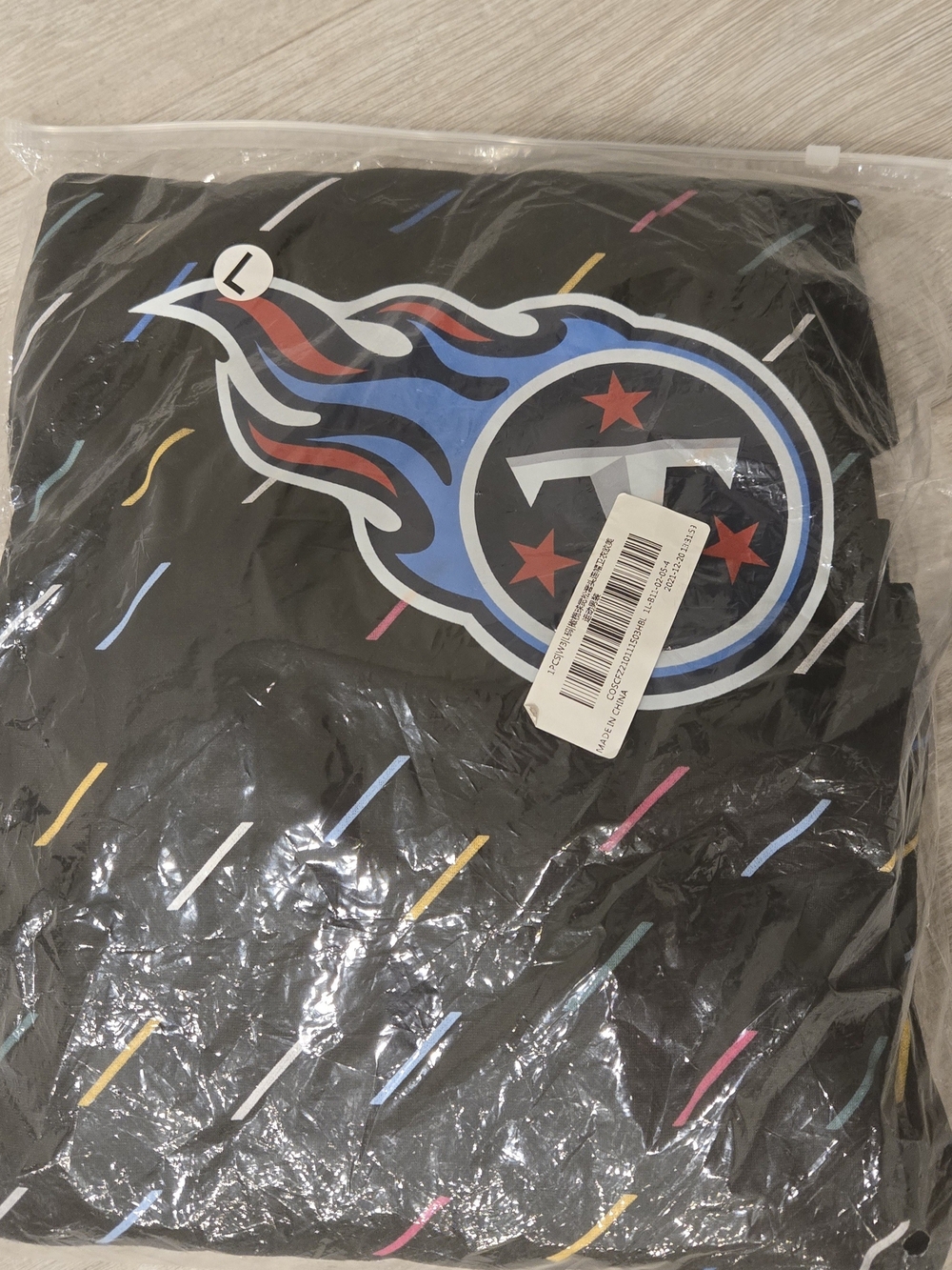 NFL Titan's Black Hoodie with Blue and Red Flame Logo and Multicolor Stripes....